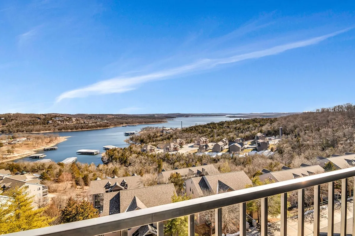 A breathtaking, expansive view of Table Rock Lake with rolling hills and scattered homes in the distance, creating a peaceful lakeside atmosphere ideal for outdoor adventures and relaxation.